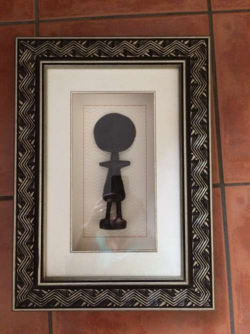 Framed wooden fertility goddess